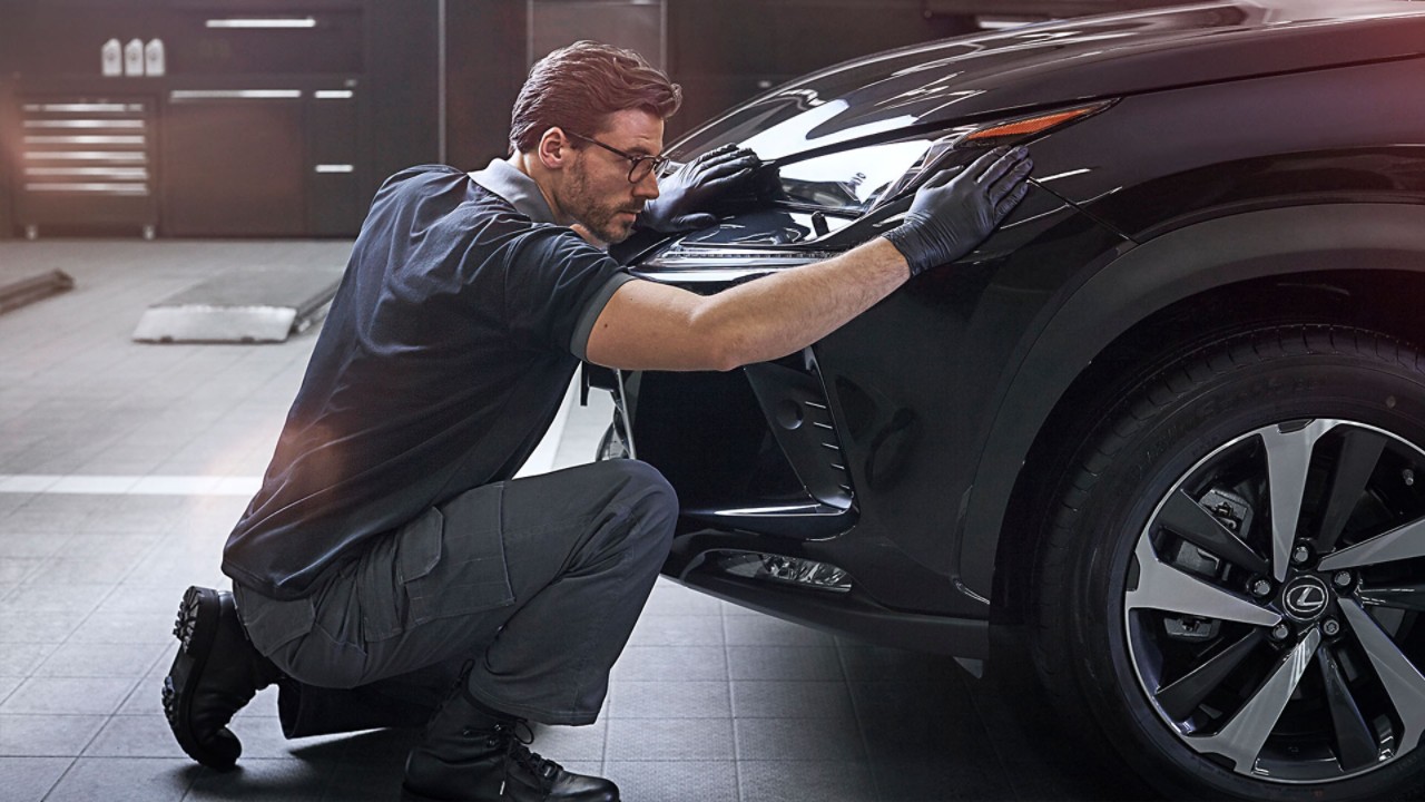 A Lexus mechanic changing a cars engine oil 