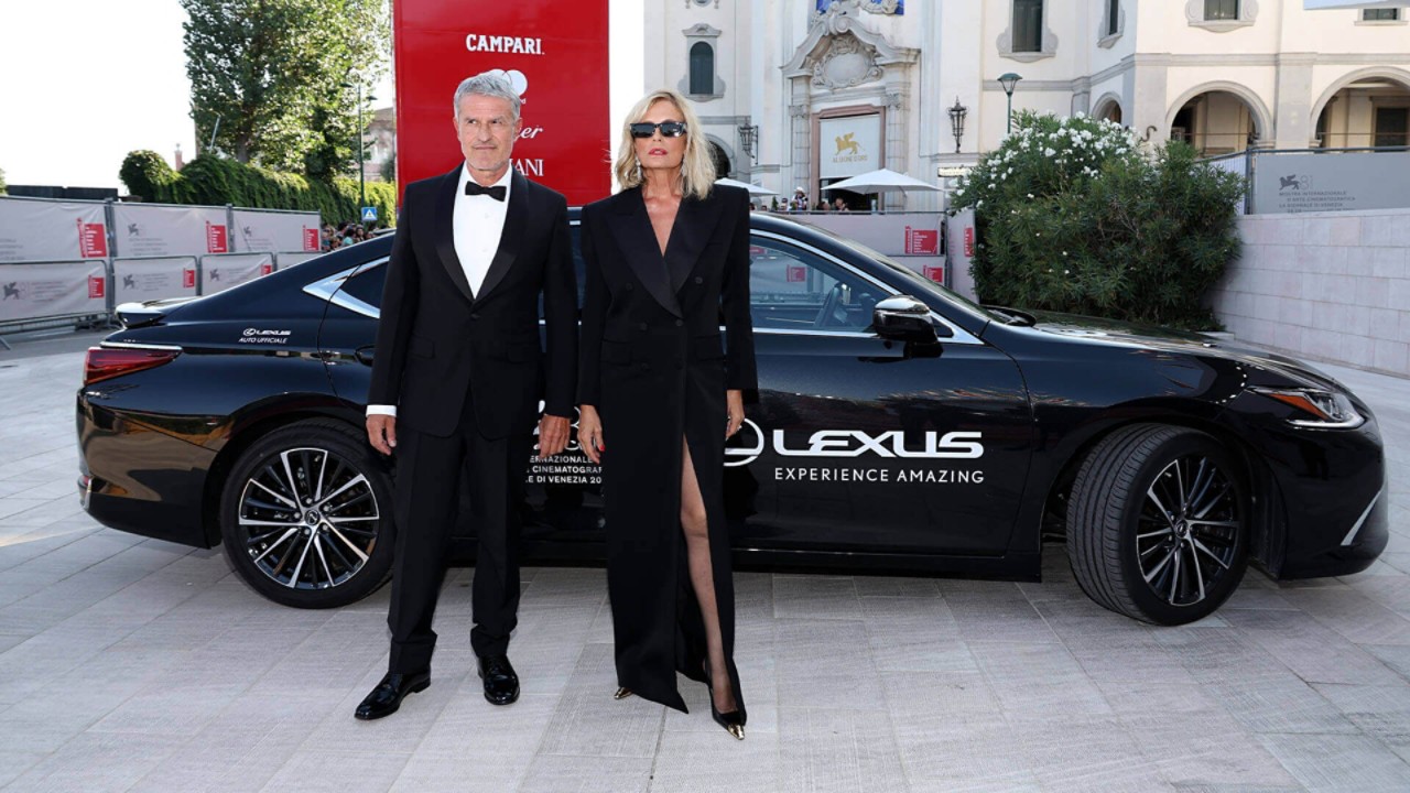 Renato De Maria and Isabella Ferrari stood in front of a Lexus at the Venice Film Festival.